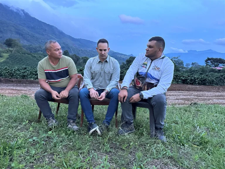 Cleiver Colmenárez, Carlos Núñez y el alcalde de Andrés Eloy Blanco, Wilmer Granadillo, sentados delante de los cafetales de la Finca Santo Cristo, en Sanare (Lara, Venezuela), al atardecer